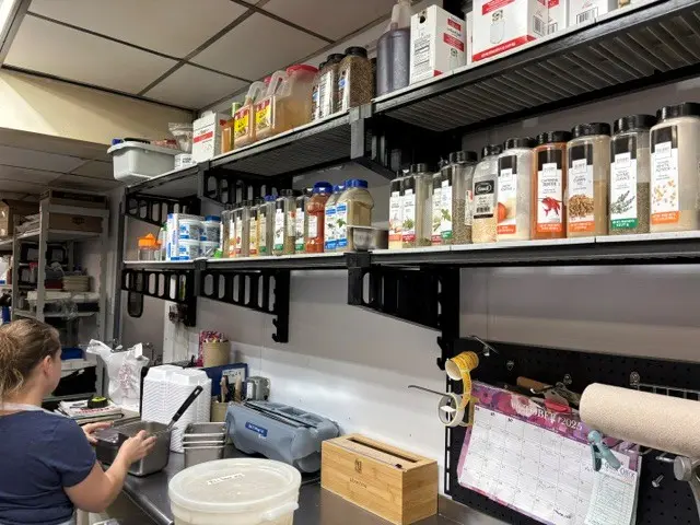 Spices and kitchen supplies organized on Elevation wall shelving