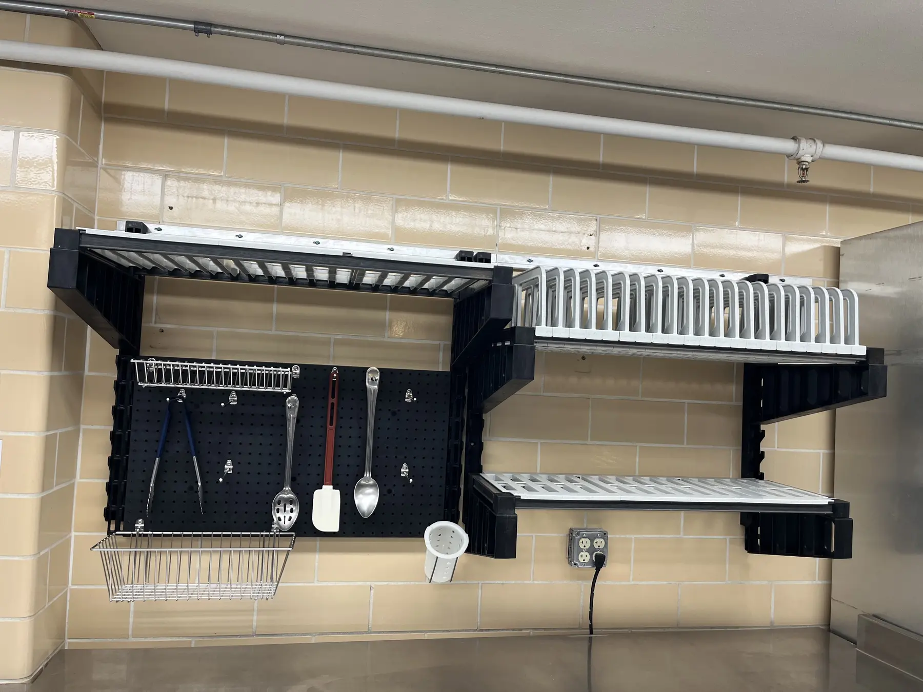 Clean modular wall shelving configuration above a prep counter