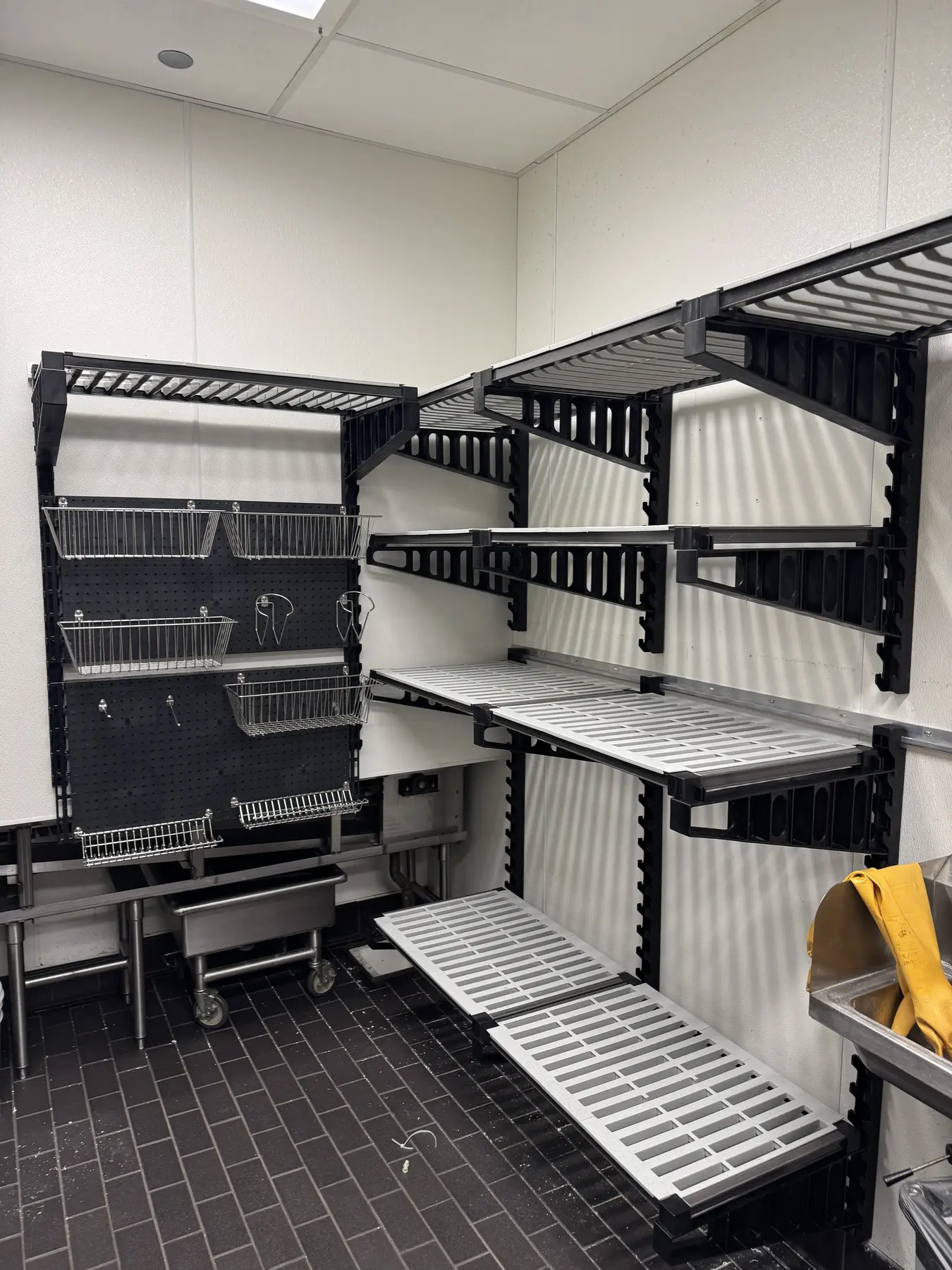 A full wall of modular shelving in a commercial kitchen